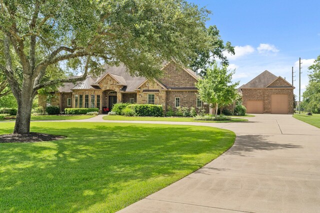 32723 Westminster Dr, Fulshear, TX 77441 - view of front of home with a garage, curved driveway, and a front yard
