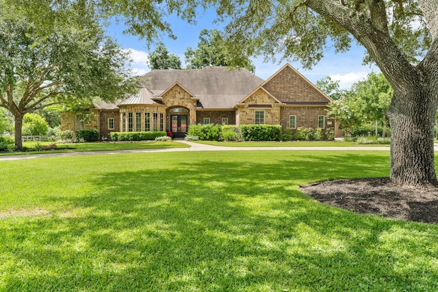 32723 Westminster Dr, Fulshear, TX 77441 - view of front of property featuring a front lawn, brick siding, and french doors