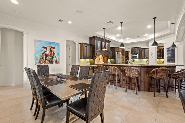 32723 Westminster Dr, Fulshear, TX 77441 - dining space with ornate columns, light tile patterned flooring, ornamental molding, a tray ceiling, and recessed lighting