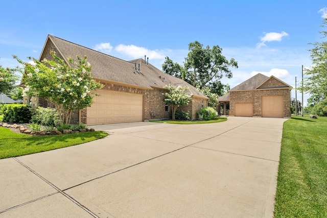 32723 Westminster Dr, Fulshear, TX 77441 - view of front facade with brick siding, an attached garage, driveway, and a front yard