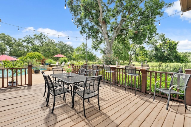32723 Westminster Dr, Fulshear, TX 77441 - wooden terrace featuring outdoor dining area and an outdoor pool