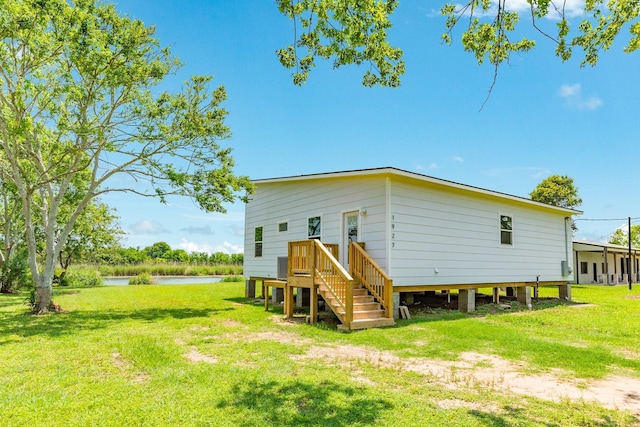 1927 Duncan Dr, Oyster Creek, TX 77541 - back of house with a lawn and a water view