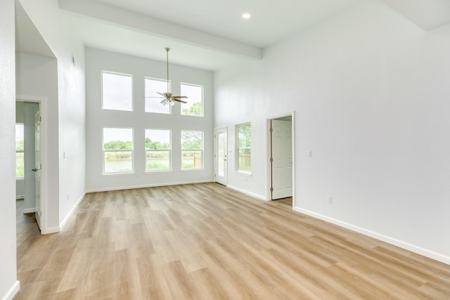 1927 Duncan Dr, Oyster Creek, TX 77541 - unfurnished living room with ceiling fan, light wood finished floors, a high ceiling, and recessed lighting