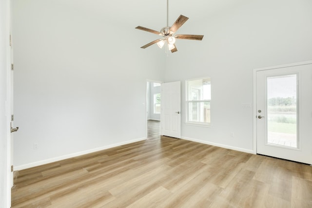 1927 Duncan Dr, Oyster Creek, TX 77541 - empty room with light wood-type flooring, ceiling fan, and a high ceiling