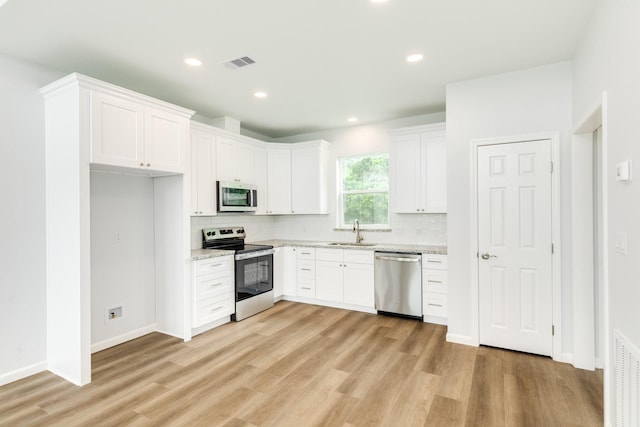 1927 Duncan Dr, Oyster Creek, TX 77541 - kitchen with appliances with stainless steel finishes, decorative backsplash, light wood finished floors, and recessed lighting