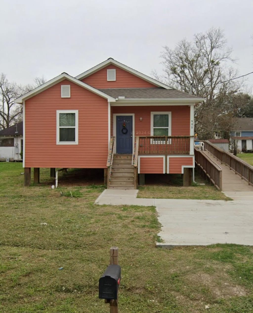 905 W Burleson St, Wharton, TX 77488 - bungalow with a front yard, stairway, a porch, and a shingled roof