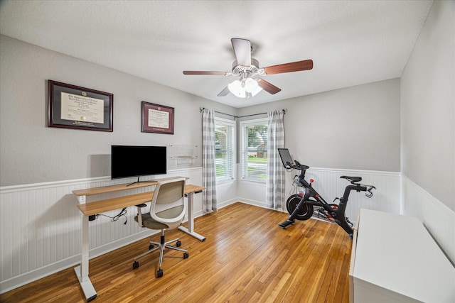 6518 Lindyann Ln, Houston, TX 77008 - home office featuring light wood-style flooring, wainscoting, and a ceiling fan