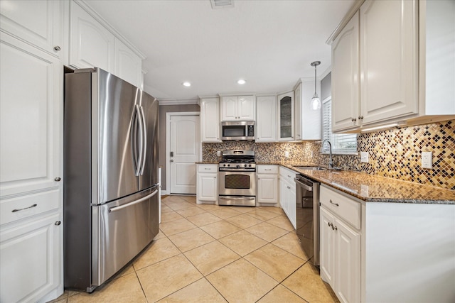 6518 Lindyann Ln, Houston, TX 77008 - kitchen with stainless steel appliances, white cabinetry, light tile patterned floors, backsplash, and stone countertops