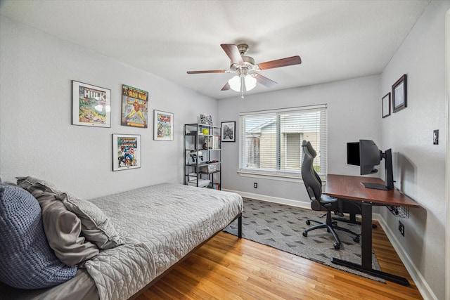 6518 Lindyann Ln, Houston, TX 77008 - bedroom featuring wood finished floors, an office area, and a ceiling fan