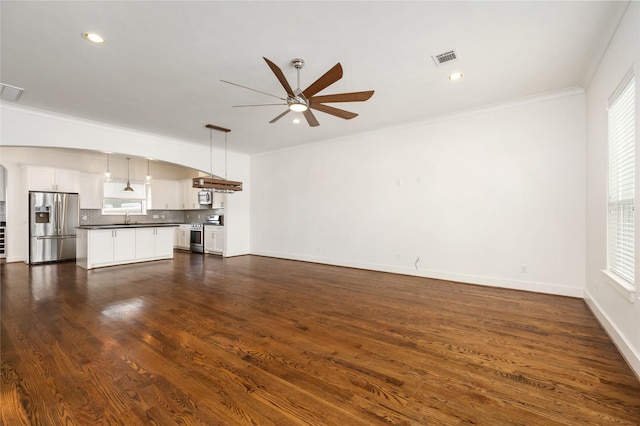 829 Wakefield Dr Unit A, Houston, TX 77018 - unfurnished living room featuring a ceiling fan, plenty of natural light, crown molding, dark wood-style floors, and recessed lighting