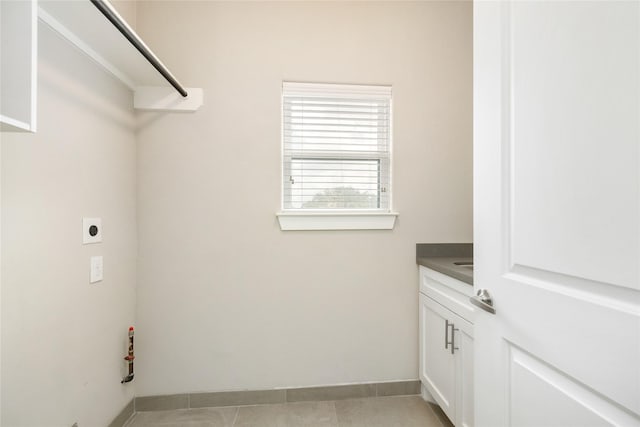 829 Wakefield Dr Unit A, Houston, TX 77018 - laundry area with cabinet space, hookup for an electric dryer, and light tile patterned floors