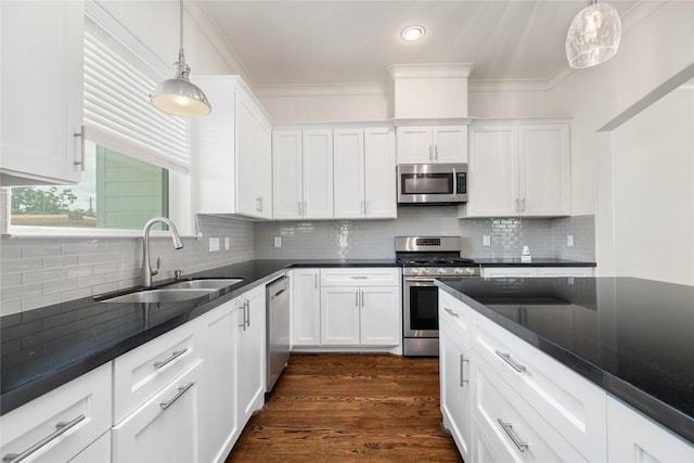 829 Wakefield Dr Unit A, Houston, TX 77018 - kitchen featuring stainless steel appliances, dark countertops, white cabinets, ornamental molding, and recessed lighting