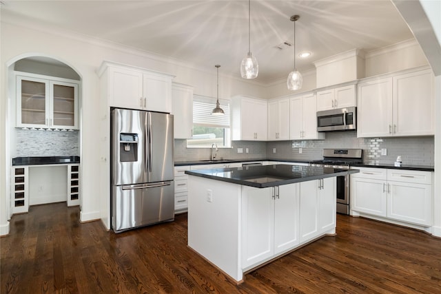 829 Wakefield Dr Unit A, Houston, TX 77018 - kitchen with stainless steel appliances, dark countertops, ornamental molding, white cabinetry, and backsplash