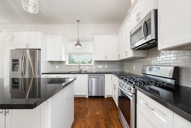 829 Wakefield Dr Unit A, Houston, TX 77018 - kitchen with stainless steel appliances, dark countertops, white cabinets, and crown molding