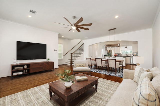 829 Wakefield Dr Unit A, Houston, TX 77018 - living area featuring arched walkways, ornamental molding, stairway, a ceiling fan, and wood finished floors