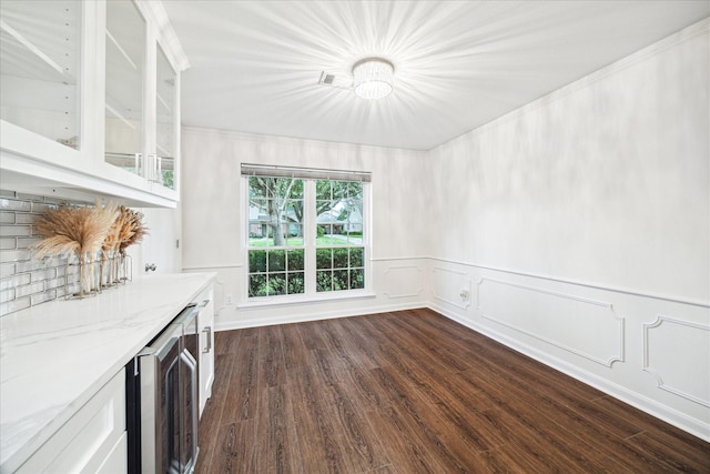 10014 Moorberry Ln, Houston, TX 77080 - unfurnished living room featuring wine cooler, dark wood finished floors, and wainscoting