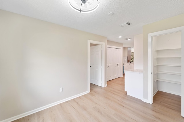 11114 Daybreak Ln, Cypress, TX 77429 - spare room with light wood-style flooring, a textured ceiling, and recessed lighting