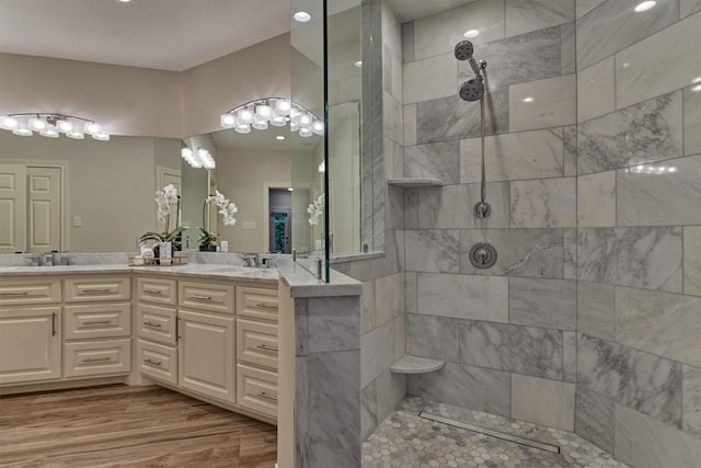 62 N Turtle Rock Ct, The Woodlands, TX 77381 - full bathroom featuring walk in shower, double vanity, and wood finished floors