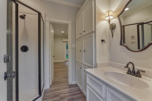 62 N Turtle Rock Ct, The Woodlands, TX 77381 - bathroom featuring a stall shower, crown molding, wood finished floors, vanity, and recessed lighting
