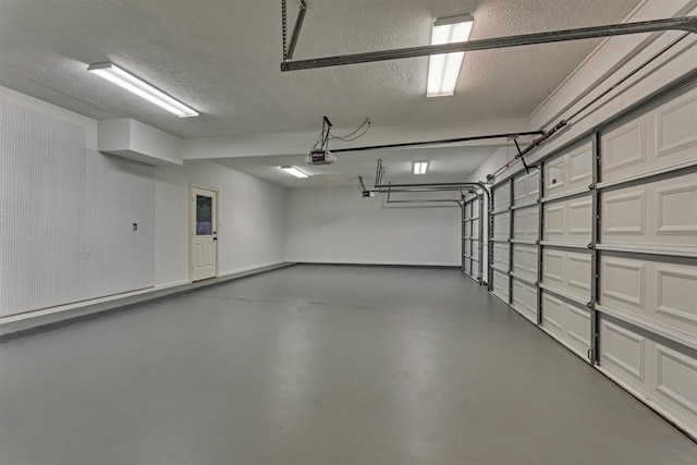 62 N Turtle Rock Ct, The Woodlands, TX 77381 - garage with a garage door opener and baseboards