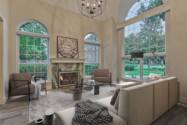 62 N Turtle Rock Ct, The Woodlands, TX 77381 - living area with plenty of natural light, wood finished floors, a chandelier, and a high ceiling