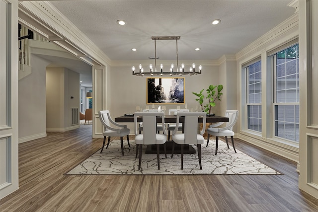 62 N Turtle Rock Ct, The Woodlands, TX 77381 - dining space featuring a chandelier, wood finished floors, ornamental molding, a textured ceiling, and recessed lighting