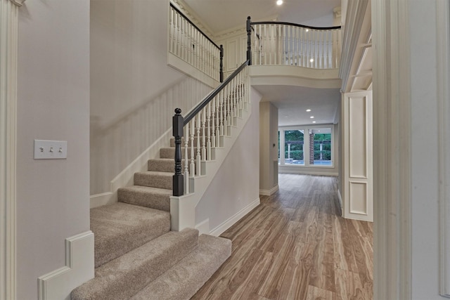 62 N Turtle Rock Ct, The Woodlands, TX 77381 - stairway with wood finished floors and a high ceiling