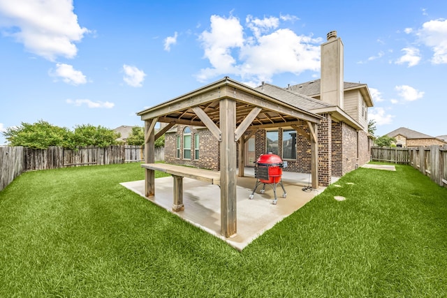23414 Bracino Lake Dr, Katy, TX 77493 - rear view of property with brick siding, a patio area, a gazebo, a fenced backyard, and a chimney