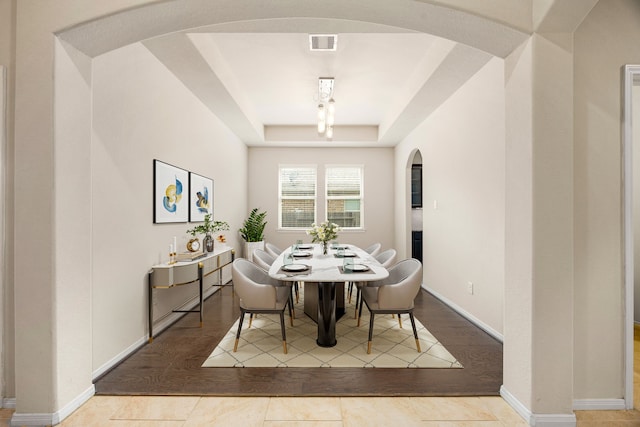 23414 Bracino Lake Dr, Katy, TX 77493 - dining space featuring arched walkways, a raised ceiling, and wood finished floors