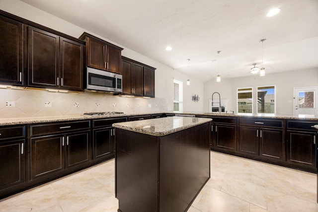 23414 Bracino Lake Dr, Katy, TX 77493 - kitchen featuring stainless steel appliances, a kitchen island, light stone countertops, tasteful backsplash, and a peninsula
