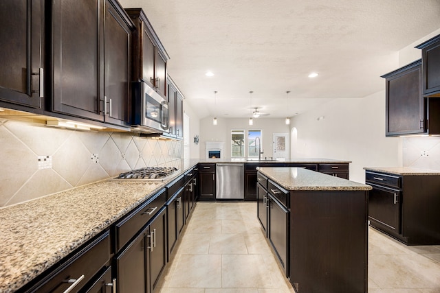 23414 Bracino Lake Dr, Katy, TX 77493 - kitchen featuring stainless steel appliances, a peninsula, light stone countertops, tasteful backsplash, and recessed lighting