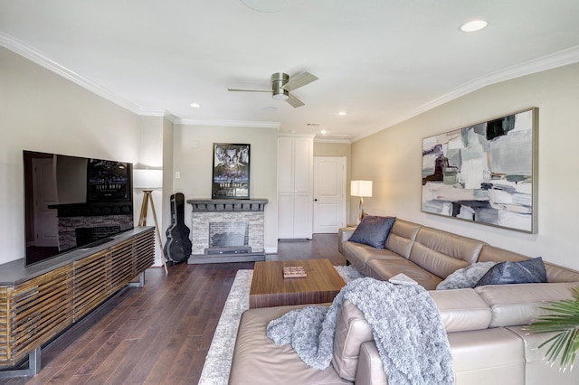 3739 University Blvd, Southside Place, TX 77005 - living room featuring a stone fireplace, a ceiling fan, crown molding, dark wood-style floors, and recessed lighting
