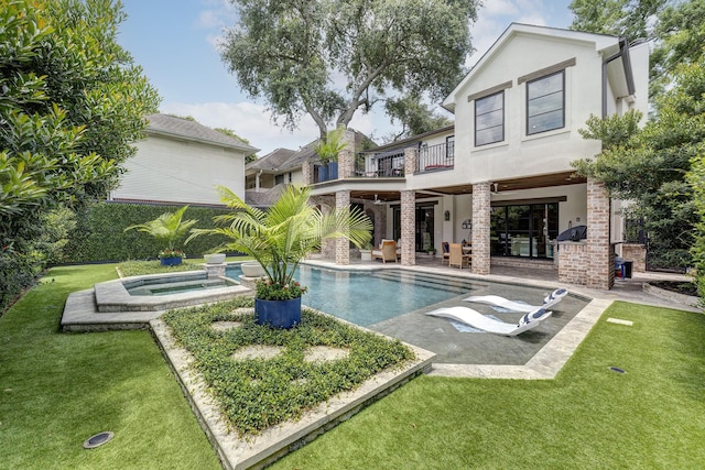 3739 University Blvd, Southside Place, TX 77005 - rear view of house with a balcony, a patio, a lawn, stucco siding, and a pool with connected hot tub