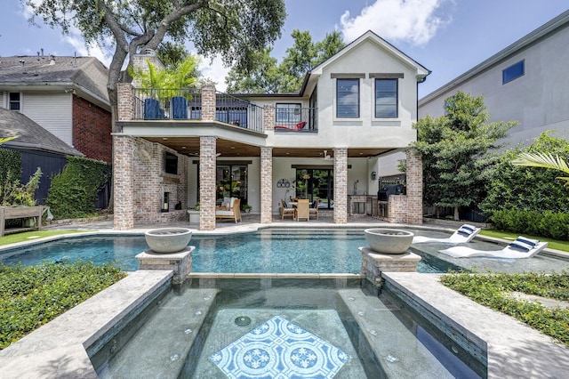 3739 University Blvd, Southside Place, TX 77005 - rear view of property featuring a balcony, an outdoor living space, a patio, and a pool with connected hot tub