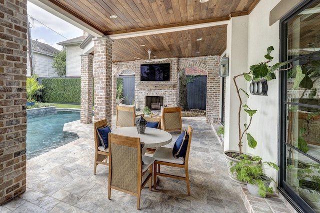 3739 University Blvd, Southside Place, TX 77005 - view of patio with an outdoor brick fireplace, outdoor dining space, and an outdoor pool