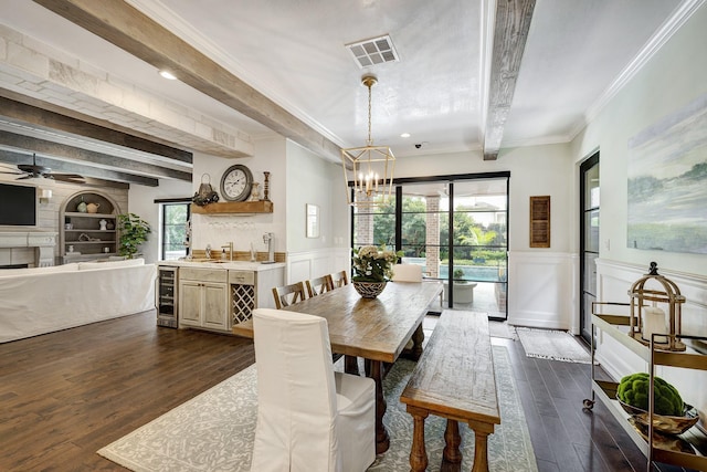 3739 University Blvd, Southside Place, TX 77005 - dining space with beam ceiling, dark wood-style floors, a chandelier, healthy amount of natural light, and a decorative wall