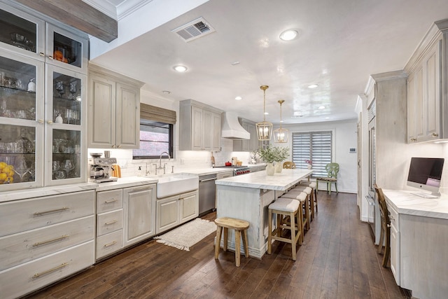 3739 University Blvd, Southside Place, TX 77005 - kitchen featuring dishwasher, a center island, recessed lighting, a kitchen bar, and premium range hood