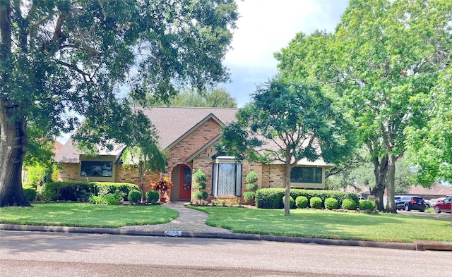 1706 23rd Ave N, Texas City, TX 77590 - english style home featuring brick siding and a front yard