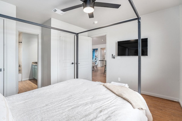 23101 Camino St, Galveston, TX 77554 - bedroom with wood finished floors, ensuite bath, and ceiling fan