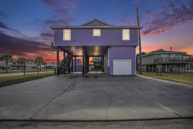 23101 Camino St, Galveston, TX 77554 - view of front of home featuring a garage, stairway, driveway, and a carport