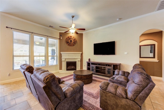 19723 Alton Springs Dr, Cypress, TX 77433 - living room with light tile patterned floors, a ceiling fan, healthy amount of natural light, crown molding, and a fireplace with raised hearth