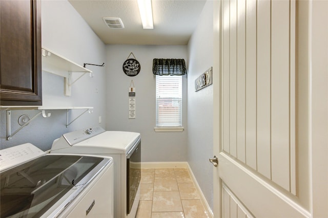 19723 Alton Springs Dr, Cypress, TX 77433 - laundry area with separate washer and dryer, light tile patterned floors, and cabinet space