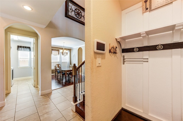 19723 Alton Springs Dr, Cypress, TX 77433 - hall featuring light tile patterned floors, a chandelier, arched walkways, recessed lighting, and a textured wall
