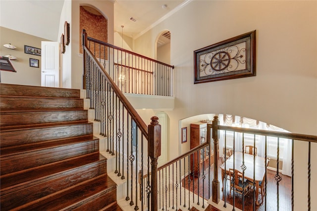 19723 Alton Springs Dr, Cypress, TX 77433 - stairs featuring arched walkways, wood finished floors, and a high ceiling