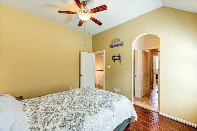 19723 Alton Springs Dr, Cypress, TX 77433 - bedroom featuring arched walkways, wood finished floors, lofted ceiling, and a ceiling fan
