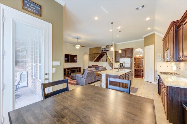 19723 Alton Springs Dr, Cypress, TX 77433 - dining room with stairs, ornamental molding, ceiling fan, recessed lighting, and arched walkways