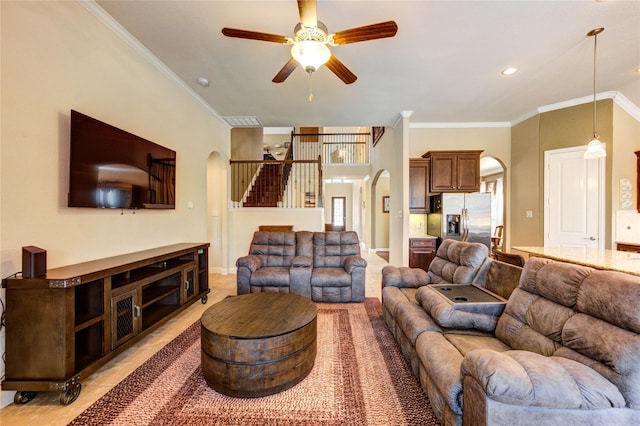 19723 Alton Springs Dr, Cypress, TX 77433 - living area featuring arched walkways, ornamental molding, a ceiling fan, light tile patterned floors, and stairway