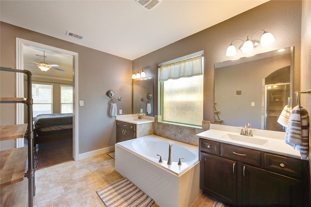 19723 Alton Springs Dr, Cypress, TX 77433 - bathroom with ensuite bath, a bath, two vanities, ceiling fan, and a stall shower