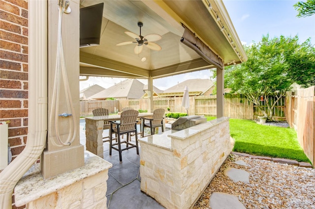 19723 Alton Springs Dr, Cypress, TX 77433 - fenced backyard with a ceiling fan, a patio area, and outdoor dining area