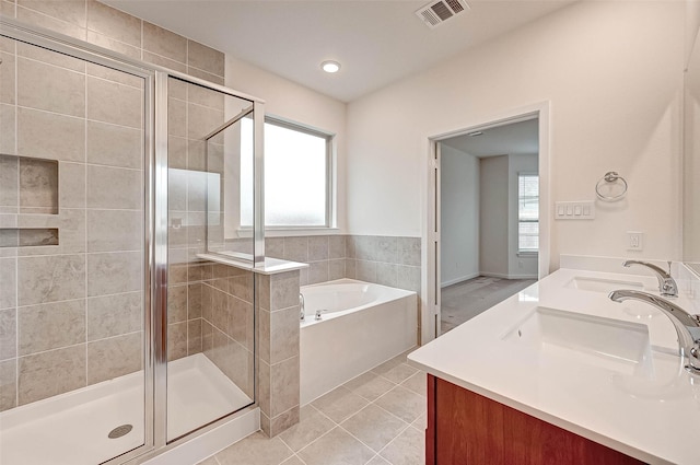 18822 Fulvetta Haven Way, Richmond, TX 77407 - bathroom featuring a garden tub, double vanity, a stall shower, and tile patterned floors